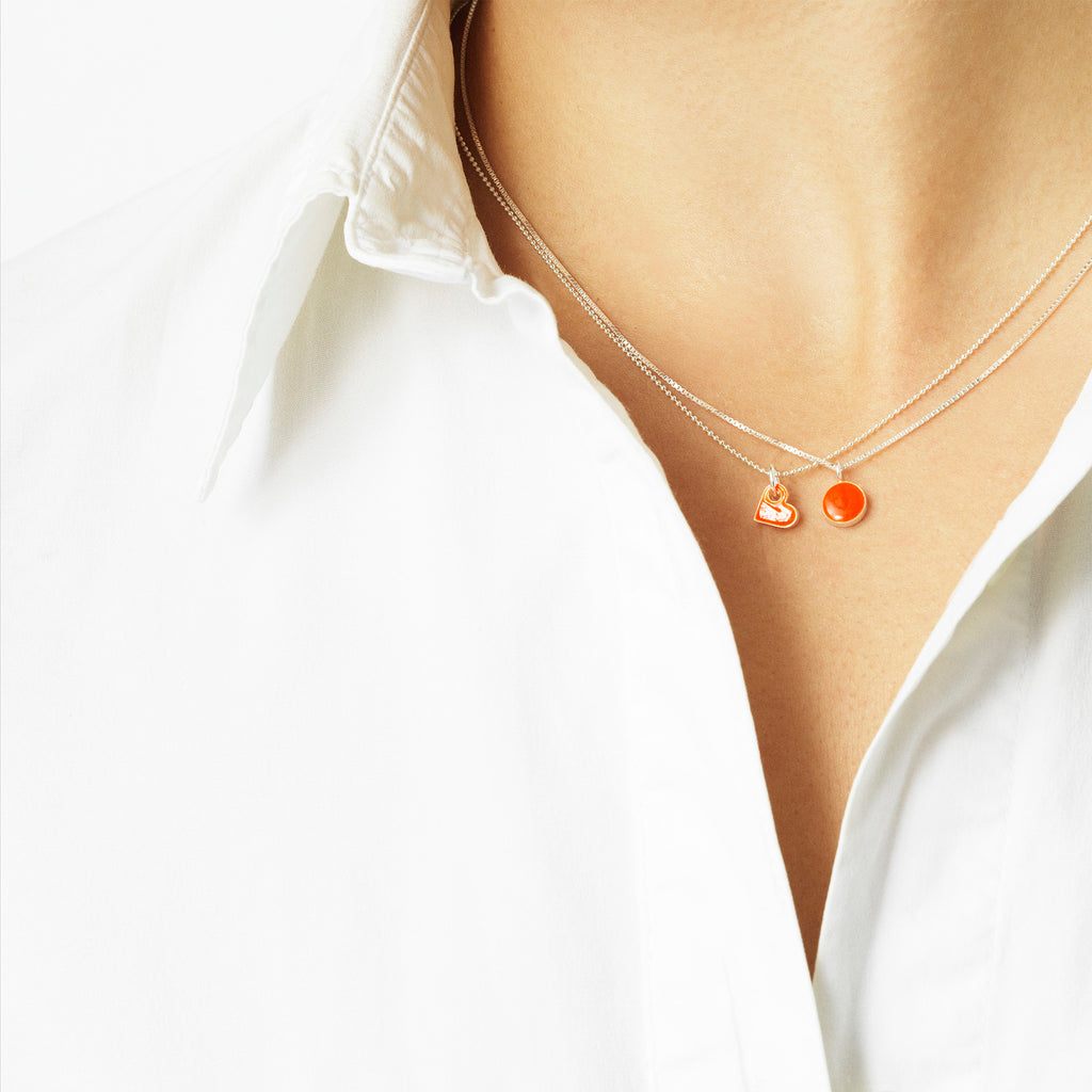 Sign necklace with pendant. Neon orange. Sterling silver. Scherning Copenhagen