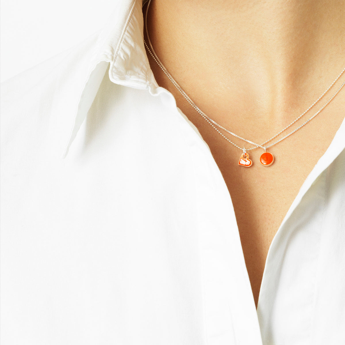 Sign necklace with pendant. Neon orange. Sterling silver. Scherning Copenhagen
