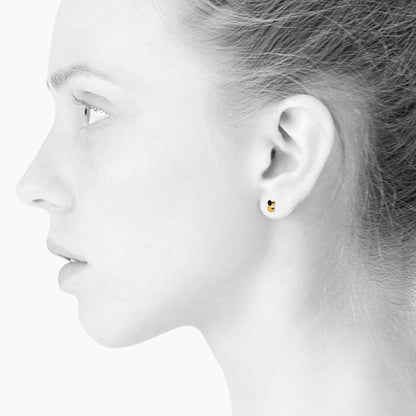 Sign Dotty nano earrings for him and her. Black and gold. Gold-plated sterling silver. Scherning Copenhagen